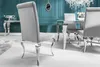 A dining room set with a table and chairs against a teal wall. Náhled obrázku produktu