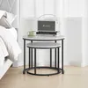 Nesting side tables next to a bed with a speaker and a mug on top. Produktbild-Vorschau
