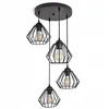 A black metal pendant light fixture with four diamond-shaped wire cages, each containing an Edison-style bulb, hanging from a circular ceiling plate. Produktbild-Vorschau