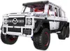 A white and black toy vehicle with six wheels. Anteprima dell’immagine prodotto