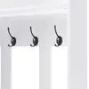 A close-up view of three black coat hooks mounted on a white surface, part of a larger furniture piece. Voir les images du produit