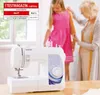 A sewing machine is shown in the foreground, with a woman measuring a young girl in a pink dress in the background. Anteprima dell’immagine prodotto