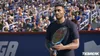 A tennis player holding a racket on a court with a crowd in the background. Produktbild-Vorschau
