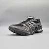 A single black and silver ASICS Gel-Kayano 14 running shoe is shown from a side angle against a plain gray background. Produktbild-Vorschau