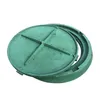 A green, circular manhole cover is shown partially open, revealing its inner workings. Podgląd zdjęcia produktu