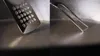 A close-up view of a frying pan with a spatula and tongs. Produktbild-Vorschau