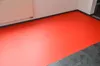 A room with a red floor covering and a white radiator. Produktbild-Vorschau