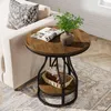A round wooden side table with a black metal frame is placed next to a sofa in a living room. Produktbild-Vorschau