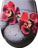 A close-up of a toilet seat with a floral and stone design. Produktbild-Vorschau