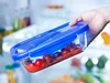 A hand is holding a glass food storage container filled with cherry tomatoes and sauce, with the inside of a refrigerator visible in the background. Anteprima dell’immagine prodotto