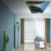 A living room with a projector displaying an image on the ceiling. Produktbild-Vorschau