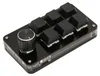 A black programmable keyboard with a rotary knob and six keys is shown on a white background. Náhľad obrázku produktu