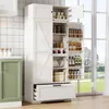 A white kitchen pantry cabinet is shown in a kitchen setting with a green cabinet to the left and a window with a view of greenery in the background. Náhled obrázku produktu