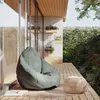 An outdoor patio setting with a bean bag chair and a small table. Náhled obrázku produktu