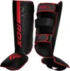 A pair of black and red shin guards for martial arts. Voir les images du produit