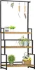 A multi-tiered plant stand with gardening tools hanging from the top. Produktbild-Vorschau