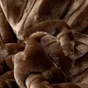 A close-up, textured view of a brown, plush blanket. Podgląd zdjęcia produktu
