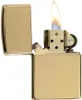 A close-up shot of a gold Zippo lighter with the lid open and a flame burning. Podgląd zdjęcia produktu