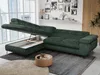 A green sectional sofa with its storage compartment open, in a modern living room setting with a large window and city view. Produktbild-Vorschau