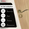 A door handle set with included hardware displayed on a wooden door. Produktbild-Vorschau