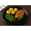 A plate of food containing grilled chicken, green beans, and potatoes. Produktbild-Vorschau
