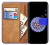 A book-style phone case with a smartphone inside, showing cards and banknotes in the case. Náhľad obrázku produktu