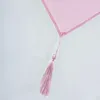 A close-up of a pink fabric with a tassel. Produktbild-Vorschau