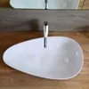 A white vessel sink with a chrome faucet is shown on a wooden countertop, with a mirrored backsplash above. Náhled obrázku produktu