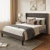 A bedroom scene with a bed, nightstand, lamp, and artwork. Náhled obrázku produktu
