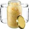 Three glass jars, one filled with sauerkraut and two empty, with a gold lid in the foreground. Anteprima dell’immagine prodotto