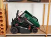 A folded electric lawnmower is stored on a shelf in a storage area. Produktbild-Vorschau