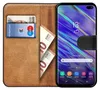 A book-style phone case with a smartphone inserted, showing cards and banknotes in the case's slots. Podgląd zdjęcia produktu