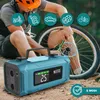 A person is using a portable jump starter and air compressor on a bicycle tire outdoors. Produktbild-Vorschau