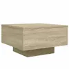 A square coffee table with a wood grain finish and a pedestal base, shown against a white background. Náhled obrázku produktu