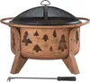 A copper-colored fire pit with tree cutouts and a black mesh screen lid, shown on a white background with a poker tool below. Produktbild-Vorschau