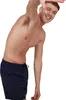 A man wearing navy blue swim shorts is posing against a white background. Produktbild-Vorschau