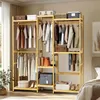 A well-lit indoor shot of a bamboo wardrobe rack filled with clothes and storage boxes. Náhled obrázku produktu