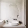 A modern bathroom vanity with a sink, faucet, and mirror. Produktbild-Vorschau