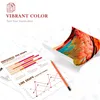 Marketing image showing a printed image of parrot feathers, a pencil, and business graphs, with text about vibrant color. Produktbild-Vorschau