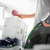 A person is holding a sanding disc over a Festool Systainer. Produktbild-Vorschau