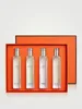 Four perfume bottles are arranged in an orange box. Voir les images du produit
