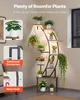 A plant stand with multiple tiers and plants on it, displayed in a room setting with soft lighting. Produktbild-Vorschau