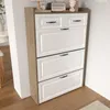 A shoe cabinet with multiple drawers and flip-down compartments, placed in a room next to a wall. Anteprima dell’immagine prodotto