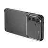A black carbon fiber look phone case with a dark gray camera module is shown from a diagonal angle against a white background. Produktbild-Vorschau