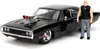 A black 1970 Dodge Charger R/T model car with a figure of Dominic Toretto from Fast & Furious standing next to it. Náhľad obrázku produktu