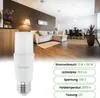 A living room scene with a sofa, dining table, and a lamp, with a product image of an LED bulb in the foreground. Produktbild-Vorschau