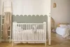 A nursery room with a crib and a glimpse into a bedroom. Podgląd zdjęcia produktu