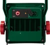 Close-up view of the back of a green LED work light, showing the power button, charging port, and battery compartment. Produktbild-Vorschau