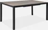 A rectangular outdoor dining table with a wood-look tabletop and black metal legs, shown from a slightly elevated angle against a white background. Anteprima dell’immagine prodotto