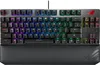 A close-up, front-facing view of a black and gray mechanical keyboard with RGB backlighting and a detachable wrist rest. Produktbild-Vorschau